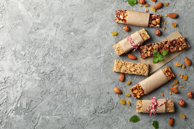 Tasty granola bars on gray background, top view