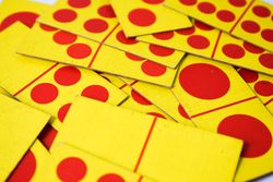 Red & yellow domino cards scattered on table