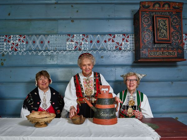 Women in traditional Norwegian clothing gather at Vesterheim, Decorah, Iowa