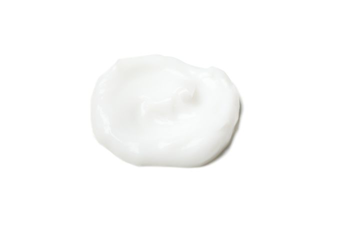 Cream spot isolated on light background. Cosmetics. Hygiene