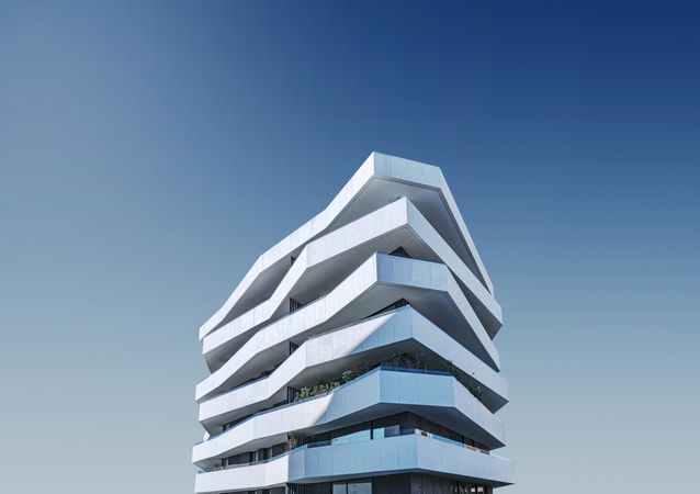 Layers on an uniquely shaped building against a blue sky