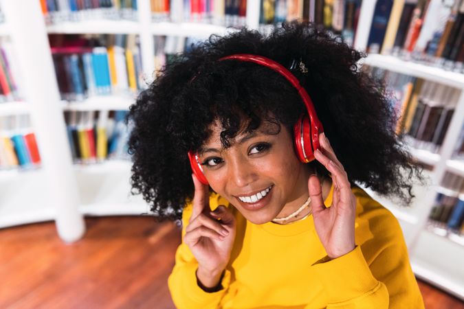 Portrait of cheerful Black woman in headphones