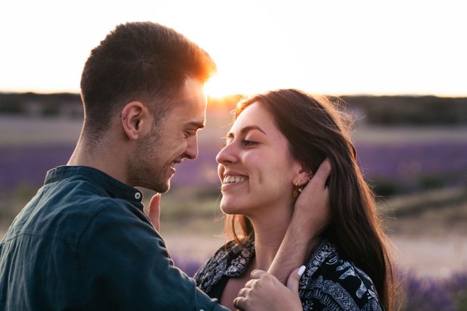 Couple in love in a lavender field at sunset