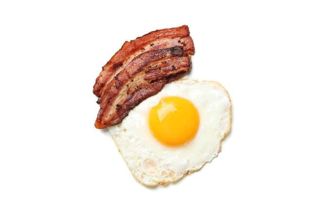 Fried egg on toast with bacon, top view