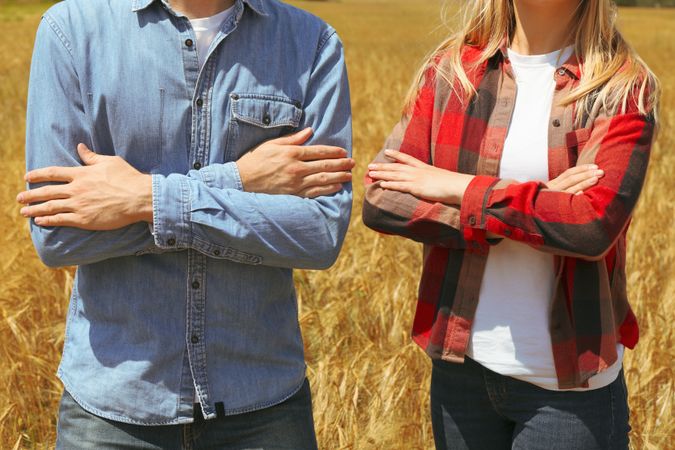 Young man and woman in barley field. Agriculture business