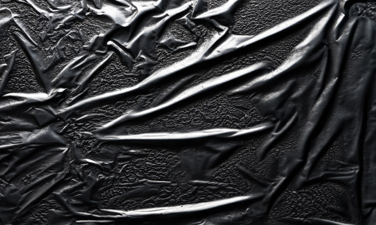 dark crumpled and creased plastic poster texture background