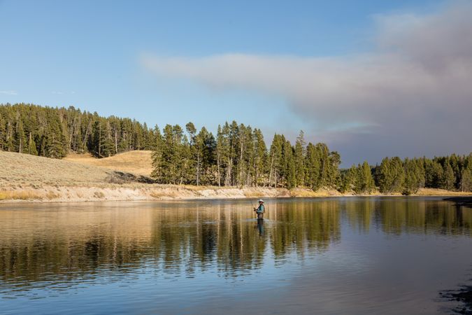 Man fly fishing in the Yellowstone River in Yellowstone National Park