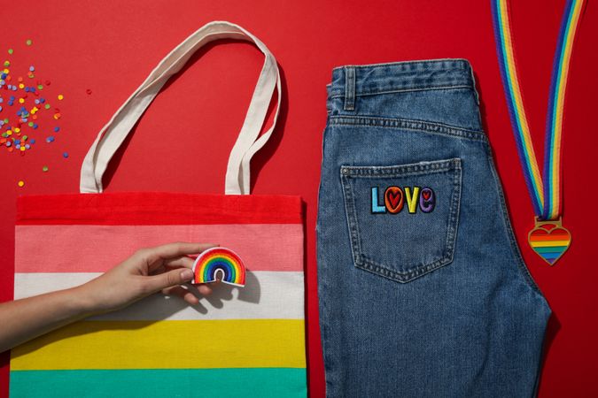 Concept of Pride parade, rainbow shopper, on color background.