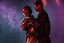 Sensual young dancers near smoke