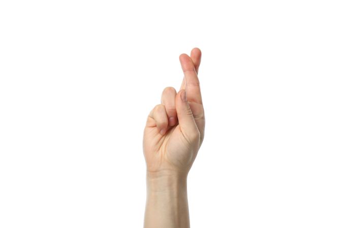 Woman hand with crossed fingers isolated on plain background