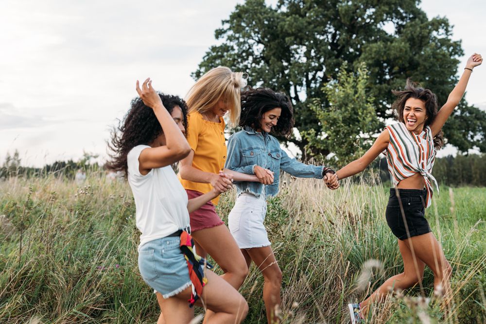 Group of four young women outside in the park