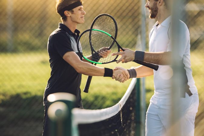 Professional tennis players shaking hands at the net