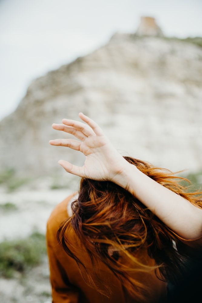 Dreamy attractive young woman posing outdoors