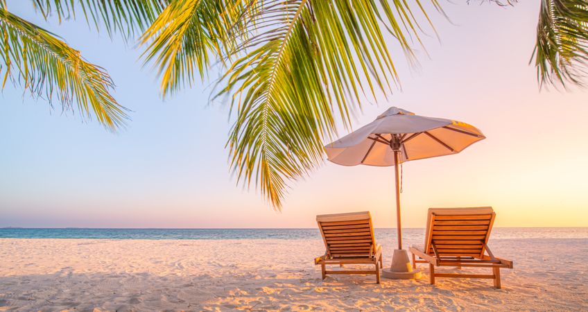 Tranquil beach with two lounge chairs