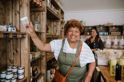 Smiling mature Black woman in soap shop