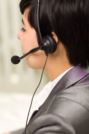Profile of Young Woman Smiles Wearing Headset
