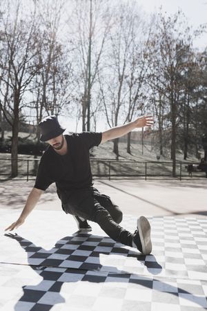Man dancing break dance in park