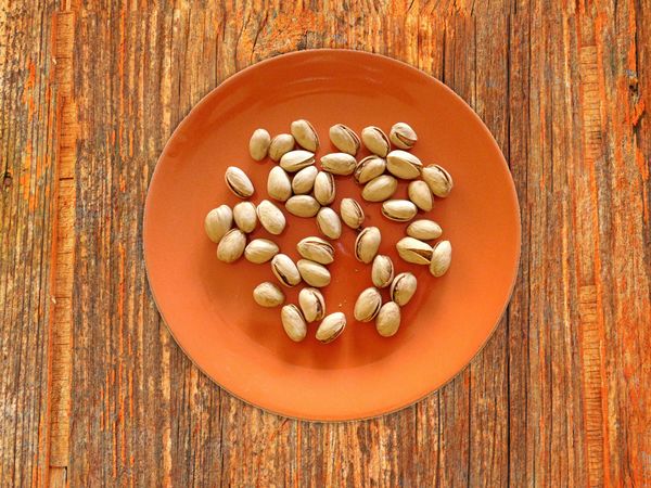Pistachios On The Wooden Background