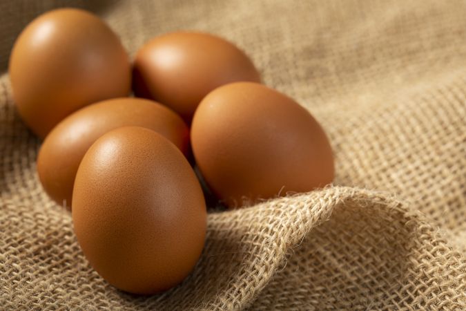 Brown chicken eggs rises on the table.