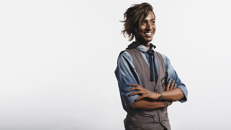 Happy Indian man in waist coat isolated on neutral background