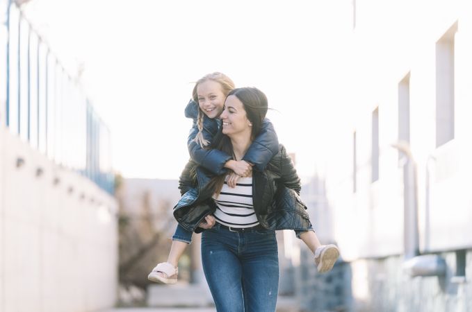 Woman doing young sister piggyback