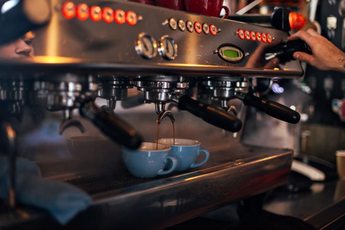 Coffee machine with espresso being poured