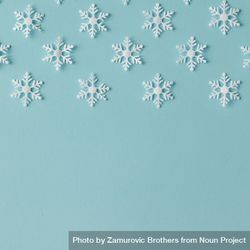Winter pattern made of uniform snowflakes on blue background 0VzLv0