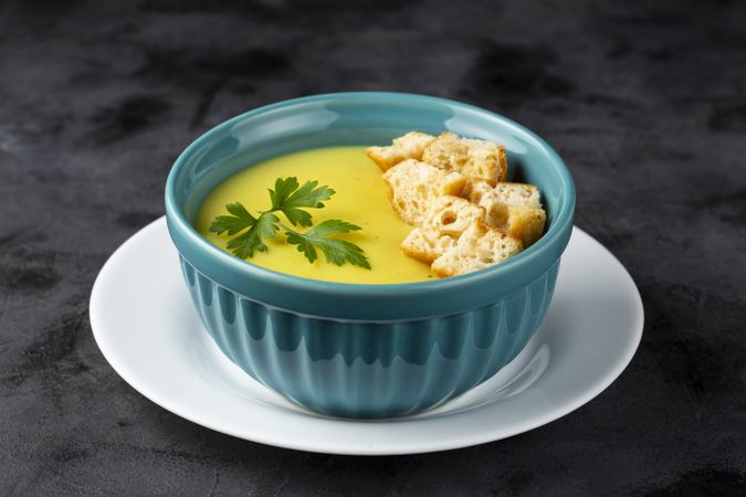 Bowl with onion soup and croutons on the table.