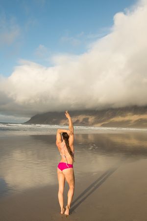 Woman stretching near sea