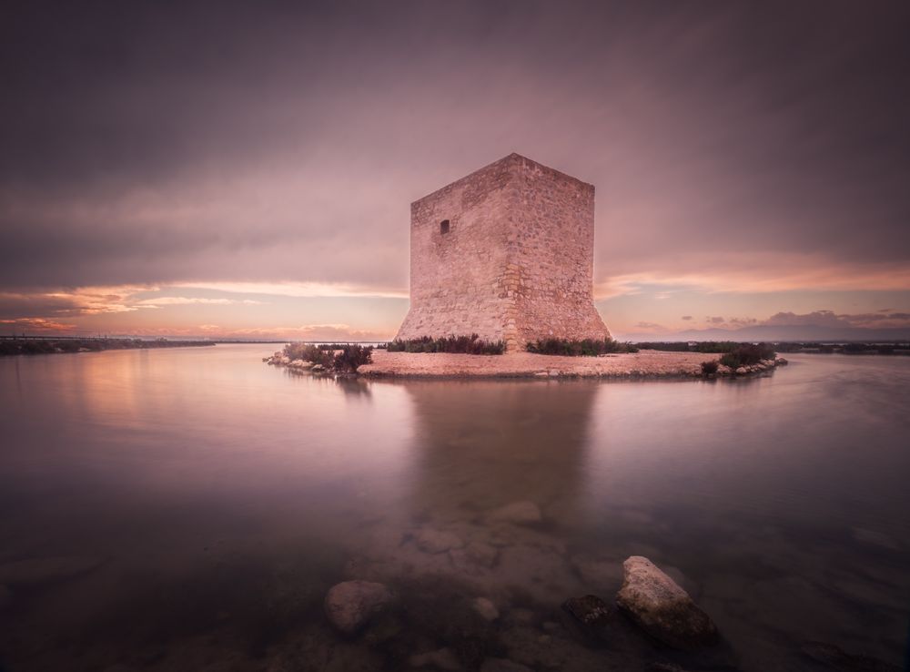 Wonderful watchtower in calm lake on cloudy day