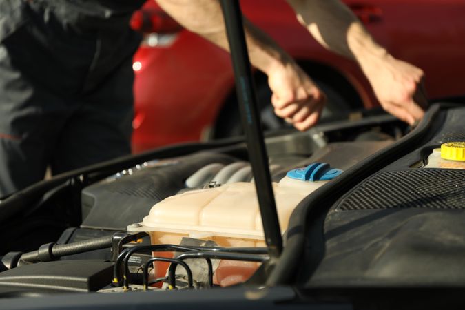 Man fixing engine. Car inspection. Work of mechanic