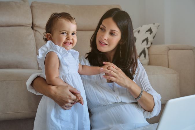 Mother and little girl spending time in living room