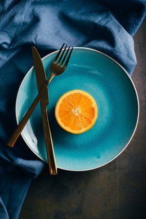 Fresh orange in a teal plate