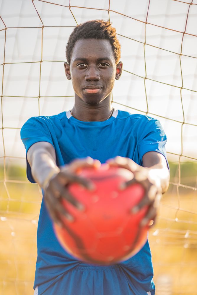 Black football player with ball
