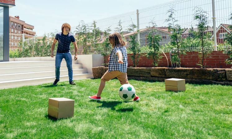 Father and son playing soccer