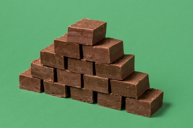 Chocolate fudge pile isolated on a green background