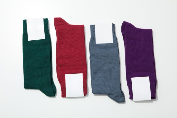 Socks with blank label on light background, space for text