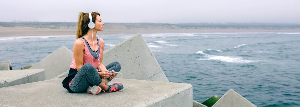 Sitting sportswoman watching the sea