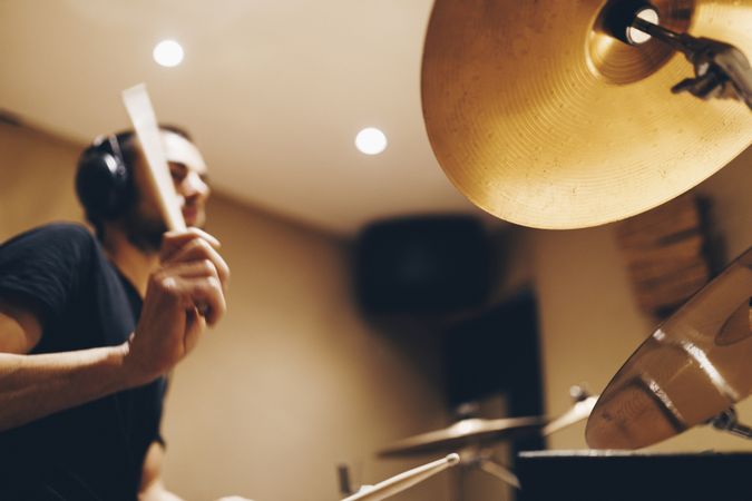 Man with headphones playing on drums