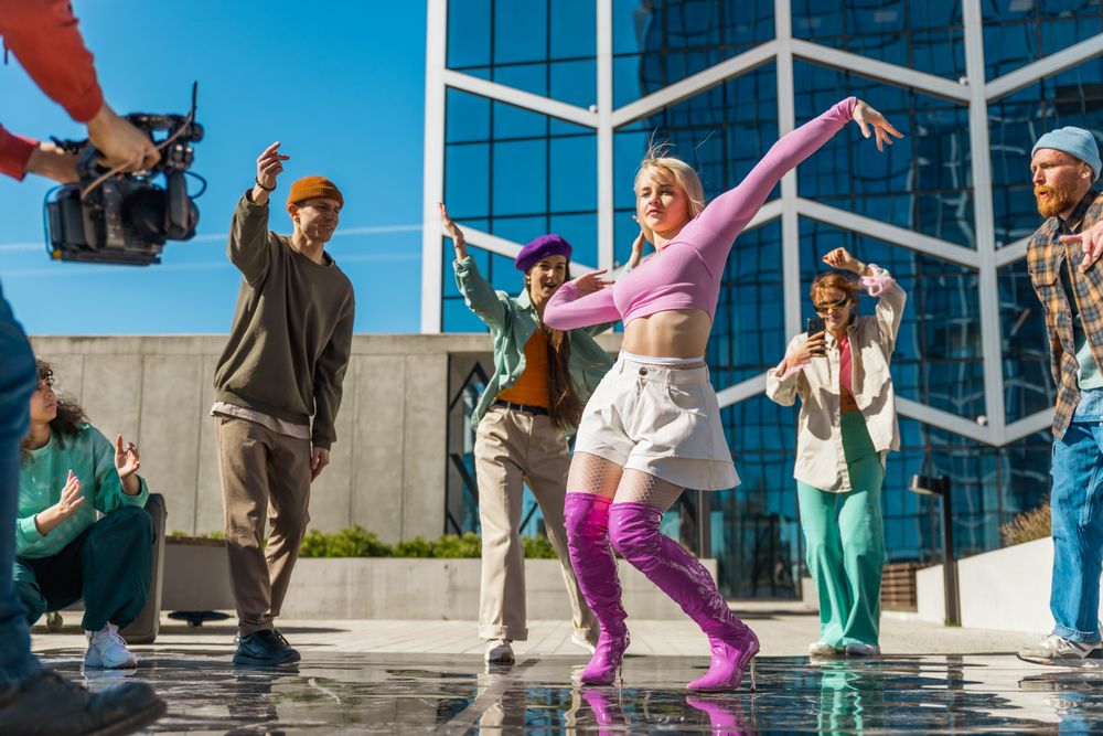 Behind The Scenes: Outdoor Scene Captures A Group Of Young Adults Joyfully Dancing In A City Plaza
