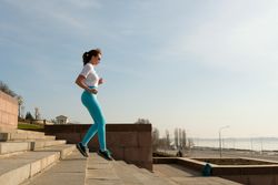 Young woman jogging on city streets