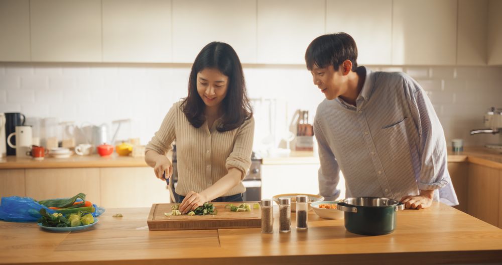 Portrait of a South Korean Young Couple Cooking at Home.