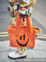 London, England, United Kingdom - September 18 2021: Person holding fluffy orange handbag 0LBdr4