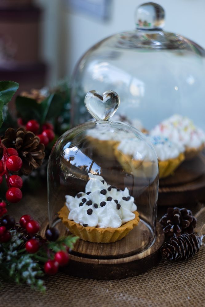 Plate of dessert pastries stuffed with cream and chocolate surrounded by holly