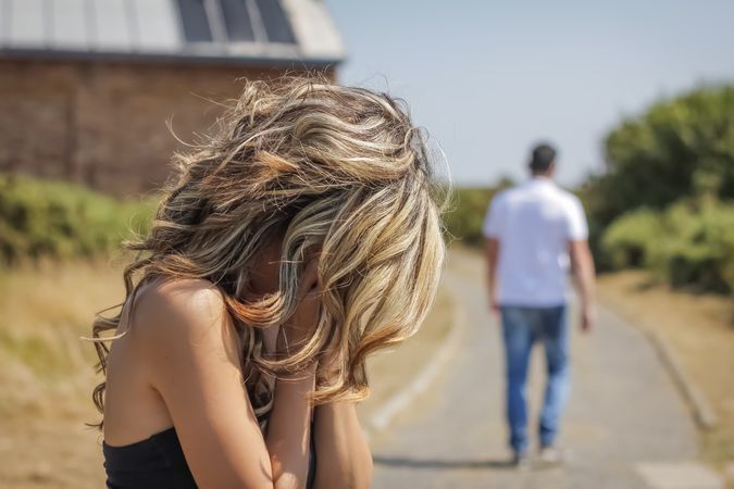 Unrecognizable man and angry woman leaving after quarrel