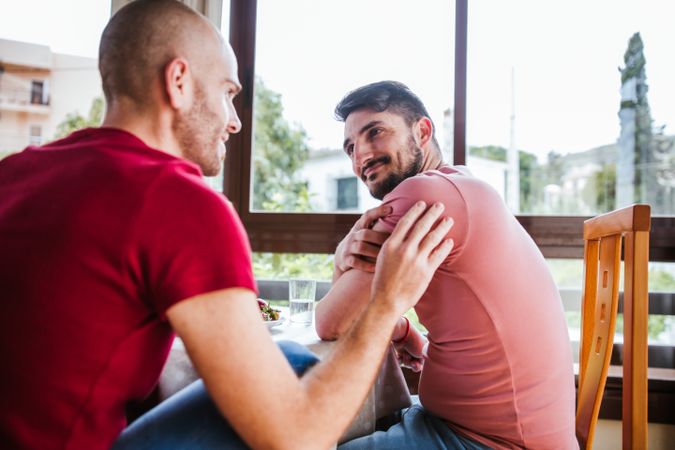 Gay couple eating strawberries