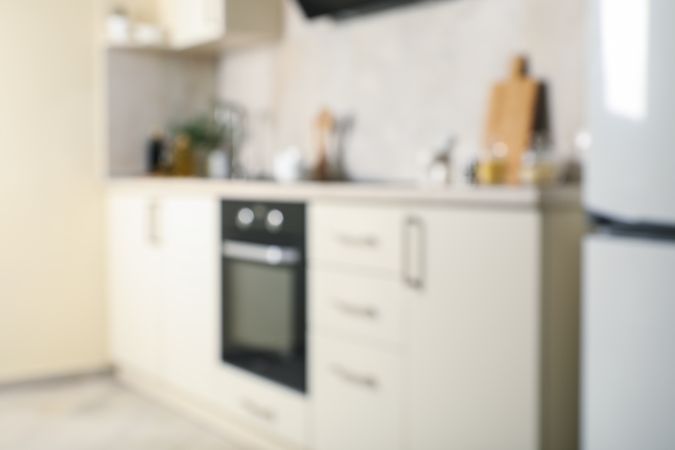 Modern kitchen interior with different supplies in light colors