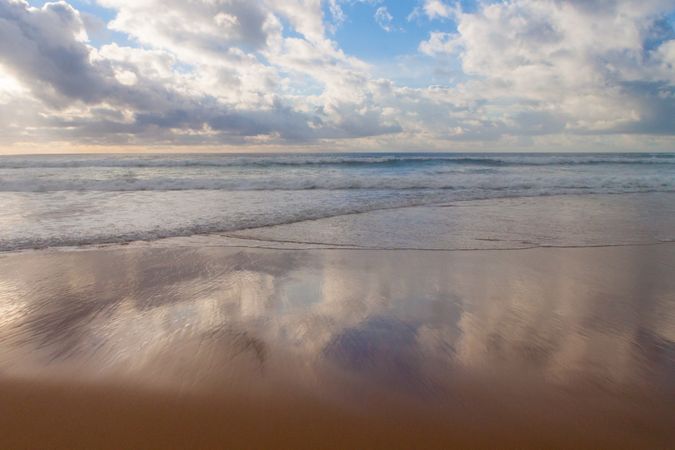 Waves coming in on calm beach in the morning