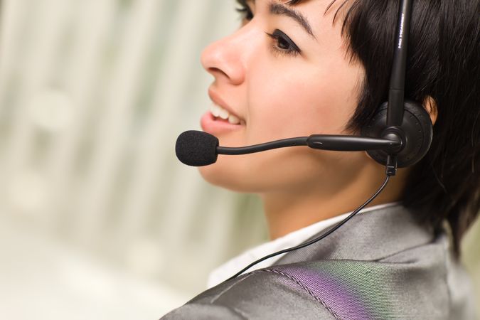 Profile of Young Woman Smiles Wearing Headset