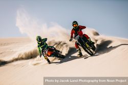 Two motocross riders speeding over the sand dunes 4jnDJ4